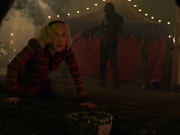 Kiernan Shipka on the ground in a short skirt